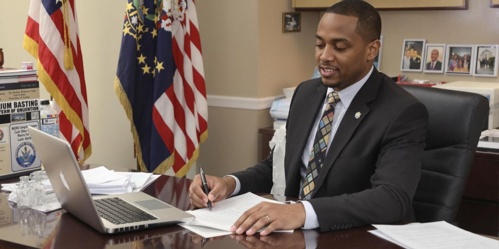 Person prepares documents at desk in government office