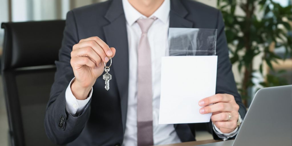 Business person holding key and cover letter confidently