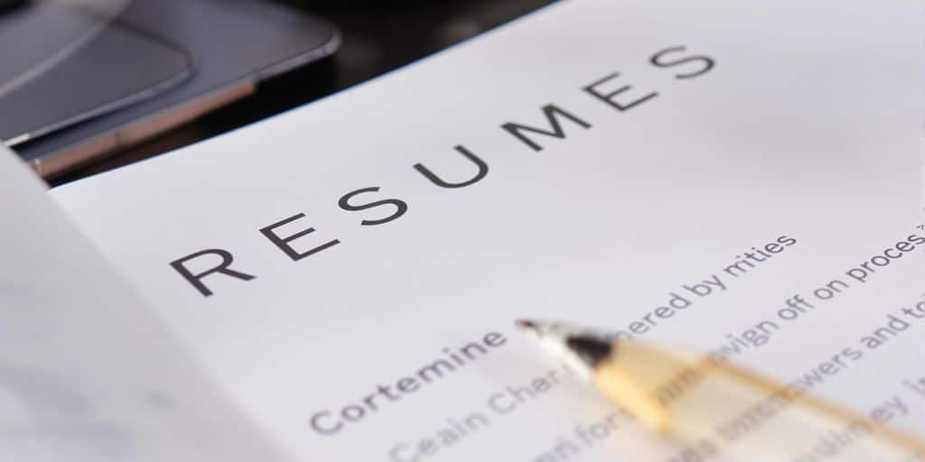 Professional resume with a pencil, illustrating career growth.