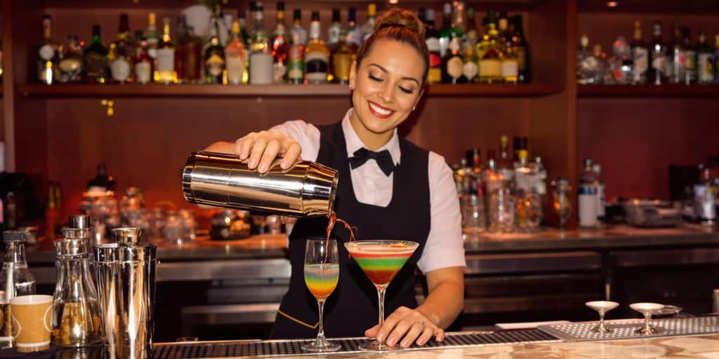 Bartender waitress pouring drinks