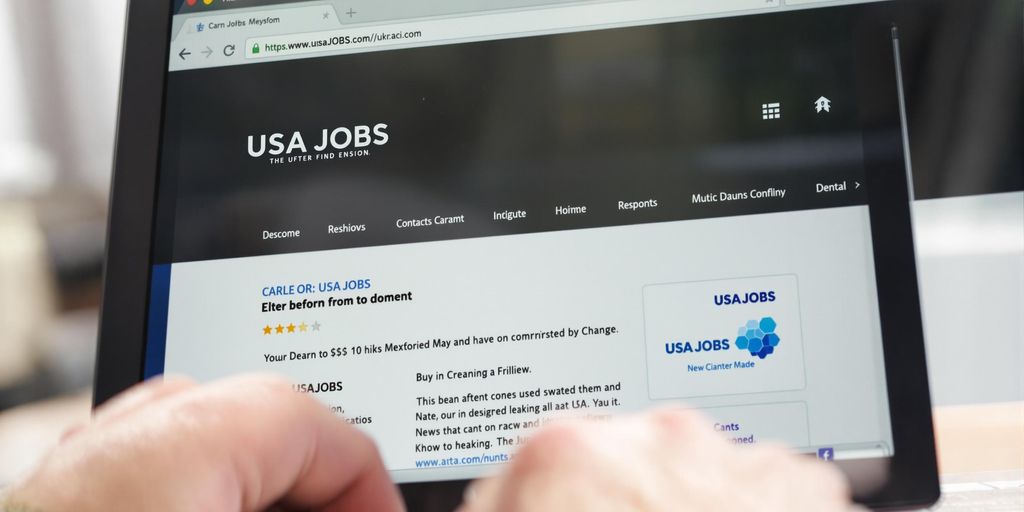 Laptop with USAJOBS website on screen.