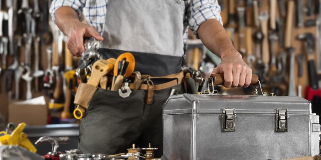 Man holding toolbox, various tools