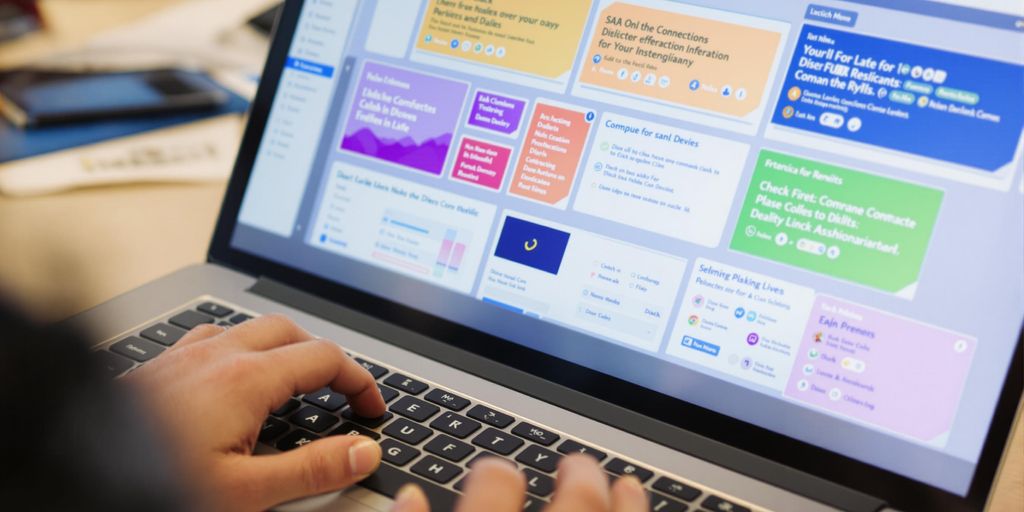 Laptop displaying SAP screens, hands typing.