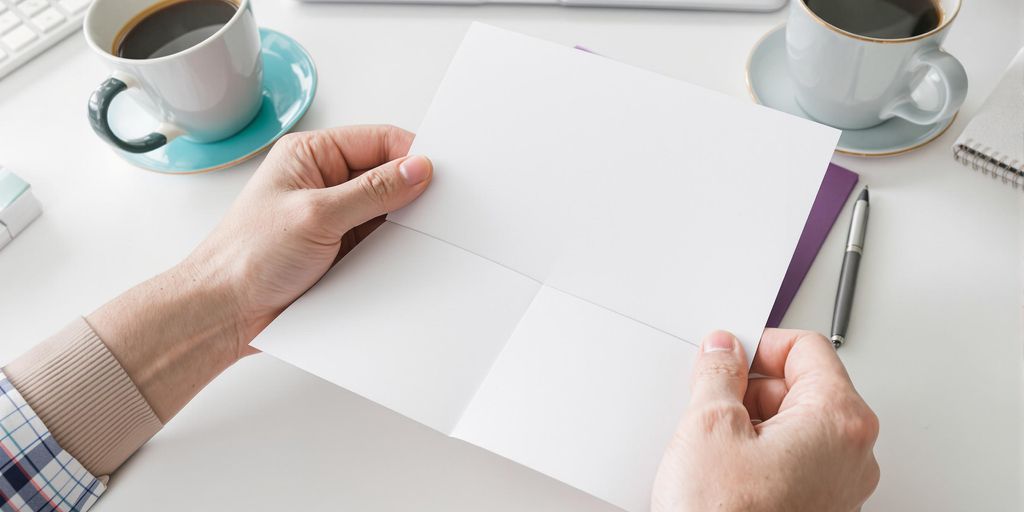 Person holding cover letter, pen, and coffee.