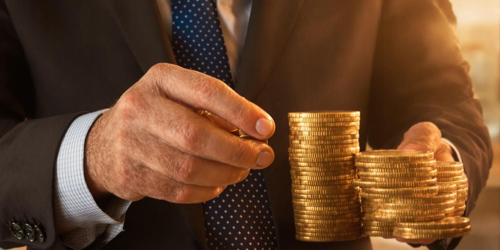 Man in suit, stacks of coins.